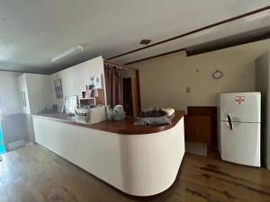 a kitchen with a counter and a refrigerator at Southern Gate HIVE in Ishigaki Island