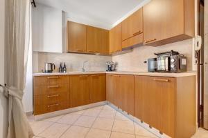 a kitchen with wooden cabinets and a microwave at Casa Donati Zago in Tremosine Sul Garda