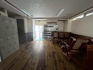 an empty room with chairs and a wooden floor at Southern Gate HIVE in Ishigaki Island