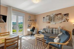 a living room with a couch and a table at Ferienwohnung Sonnenblick in Bad Berleburg
