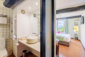 a bathroom with a sink and a bed in a room at Grimaldi in Cagnes-sur-Mer +98 photos