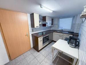 a small kitchen with a sink and a table at Ferienwohnung Knittlingen in Knittlingen