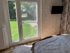 a bedroom with a large window and a bed at Ferienwohnung Wartehof in Balhorn