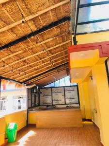 a room with a kitchen with yellow and orange walls at Rambler's Hotel in Kathmandu