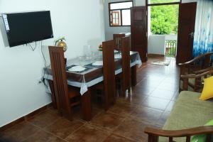 a living room with a table and a television at VILLA BLUE ROSE ,WALGAMA MADIHE Matara in Matara