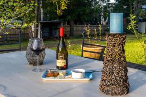 a table with a bottle of wine and a glass at Couple retreat, pet friendly Bilpin in Bilpin
