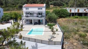 an aerial view of a house with a swimming pool at Euphoria Apartments in Kouvaláta