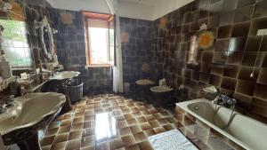 a bathroom with a tub and two sinks and a bath tub at La Via delle Rose in Tempio Pausania +21 photos