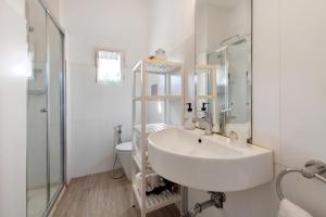 a white bathroom with a sink and a toilet at Villa Carla in Salò +17 photos