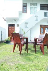 three chairs and a table in front of a house at VILLA BLUE ROSE ,WALGAMA MADIHE Matara in Matara