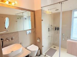 a bathroom with a shower and a sink and a toilet at Madhukar Vilas in Vrindāvan +48 photos