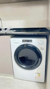 a washing machine with a shelf on top of it at مسقط العامرات in ‘Udhaybah