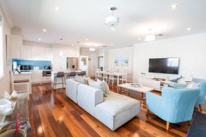 a living room with a couch and a table at The Lake House - Spacious Group Haven by the Bay in Victor Harbor