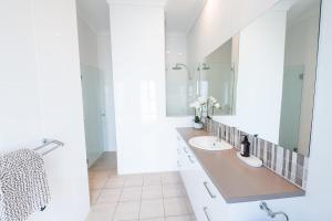 a bathroom with two sinks and a large mirror at The Lake House - Spacious Group Haven by the Bay in Victor Harbor +27 photos