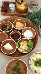 a table topped with bowls of different types of food at DARA RUM lUXURY CAMP in Wadi Rum +87 photos