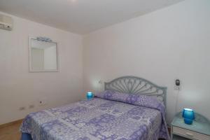 a bedroom with a bed with blue candles on it at Sole mare in Olbia