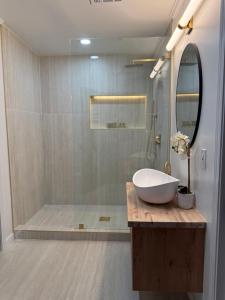 a bathroom with a white sink and a shower at The Elite House in Atlanta