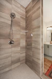 a shower with a glass door in a bathroom at New home with all the modern comforts  +20 photos
