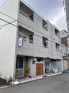 a gray brick building with a sign on it at Nono in Takamatsu +31 photos