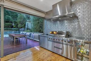 a kitchen with a stove and a table on a deck at Luxury Resort Studio Apartment Retreat with Pool, Tennis & Alfresco 