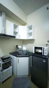 a small kitchen with a sink and a microwave at Cozy Modern Studio Overlooking the Skyline in Molo