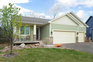 a green house with a bench in the front yard at New home with all the modern comforts 