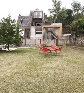 a table and chairs in front of a house at Luxe Villa in Murree