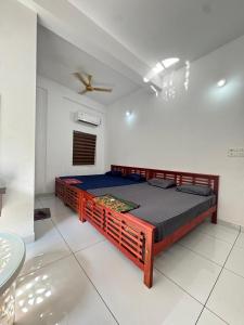 a bedroom with a bed in a room with a ceiling at Barkka in Ponnāni