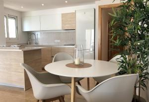 a white table and chairs in a kitchen at Front Line on the beach in Calpe
