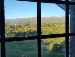 a view from a window of a mountain view at Cabañas KIMA I in Huerta Grande