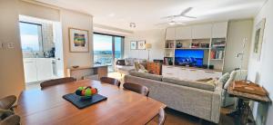 a living room with a table and a couch at Sweeping Harbour & Ocean Views Over Sydney's East in Sydney