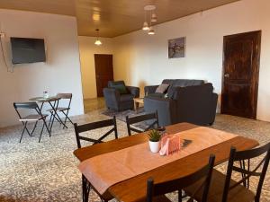 a living room with a table and chairs and a couch at Villa Verde in Perquín