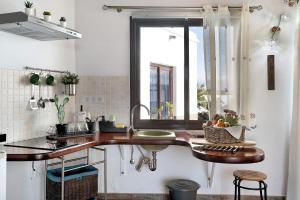 a kitchen with a counter with a sink and a window at Guenia I in Teguise