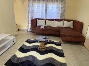 a living room with a couch and a table at Mawimbi Pearl staycations in Kilifi