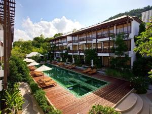 an external view of a hotel with a swimming pool at Maryoo Samui Hotel in Choeng Mon Beach