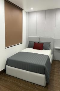 a bedroom with a large bed with a red pillow at Hoàng Huy Hotel in Cat Ba