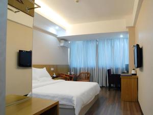 a hotel room with a bed and a desk and a television at Super 8 Hotel Fuzhou Jinjishan in Fuzhou