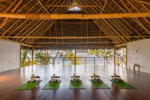 a group of chairs in a room with a wooden floor at Xinalani Retreat Mexico in Qumiste