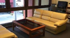 a living room with a couch and a coffee table at Hotel Town Nishikigawa in Kochi +55 photos