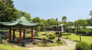 a gazebo in a park with a fountain at Time Travellers Hotel in Manila