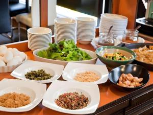 a table topped with bowls and plates of food at Mimatsu Annex in Mito
