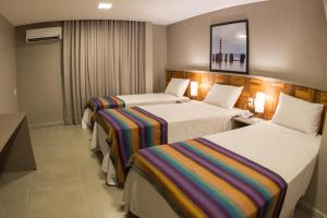 Postel nebo postele na pokoji v ubytování Amenit Hotel
