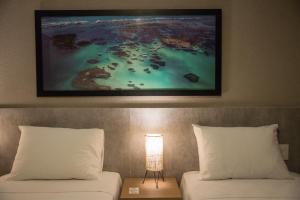 Postel nebo postele na pokoji v ubytování Amenit Hotel