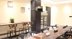 a room with tables and chairs and a refrigerator at Xana Lite Korla Xiangli Avenue Food Street in Korla