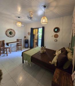 a bedroom with a bed and a living room at Little house in El Nido