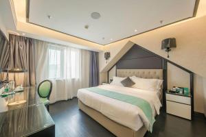 a bedroom with a large bed and a large window at Xana Hotelle·Nanchang Bayi Square Metro Station in Nanchang +244 photos