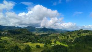 a view of a valley with mountains and trees at Kings Court Village Resort in Araku