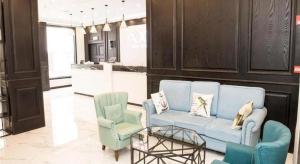 a living room with two chairs and a blue couch at Xana Lite Tianjin Beizhakou Town in Tianjin