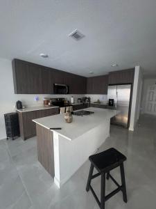 a kitchen with a island in the middle of it at Modern room with kitchen and backyard access in Homestead +1 photo