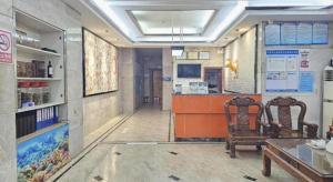 a room with two chairs and a counter in a store at PAI Hotel·Huazhou Bus Terminal in Dongshan